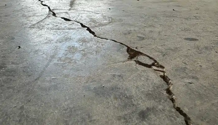 Multiple cracks in basement floor in Fairfax, VA, a warning sign of foundation movement needing expert foundation repair services.