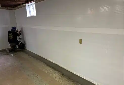 LUX team installing vapor barrier for expert basement waterproofing services in Northern Virginia, protecting homes from water damage.