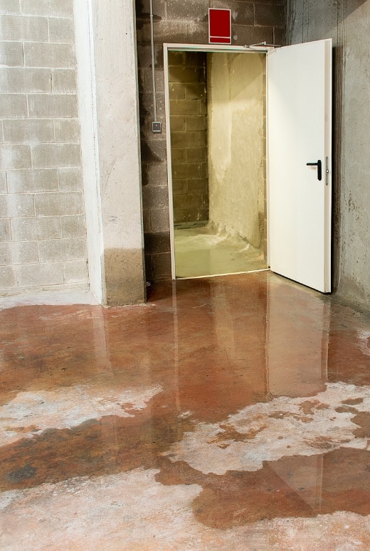 Basement with water seepage due to poor drainage and foundation cracks, showing the causes of basement water damage in Winchester, VA.