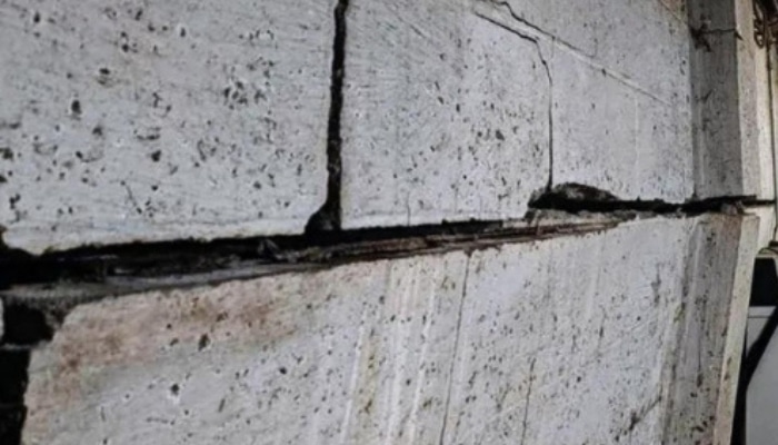 Bowing basement wall in Fairfax, VA, from surrounding soil pressure and water buildup, needs expert basement waterproofing services.