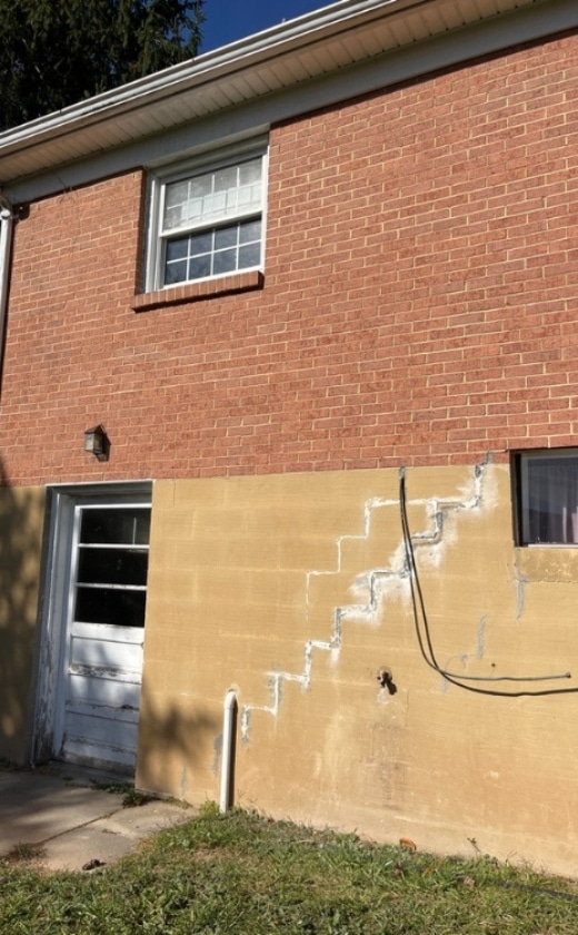 Deep foundation wall cracks caused by shifting soil and hydrostatic pressure can lead to foundation damage in Alexandria, VA.