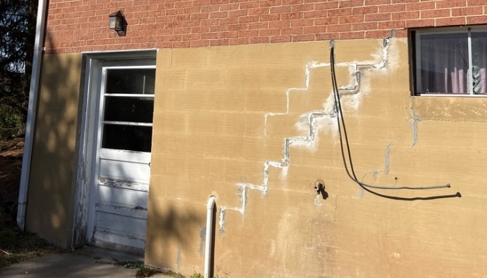 Multiple cracks in basement walls in Fairfax, VA, requiring expert basement waterproofing services to prevent further damage.