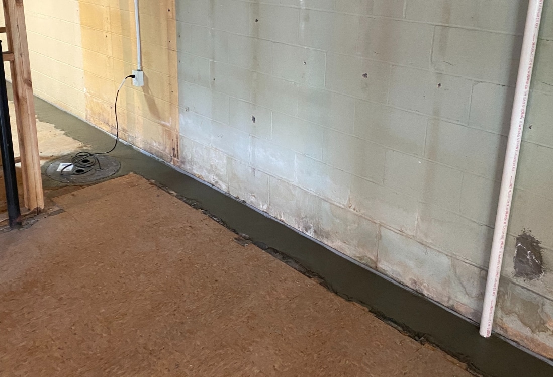 Dry and functional basement in Winchester, VA, after interior drainage system and sump pump installation by LUX Foundation Solutions.