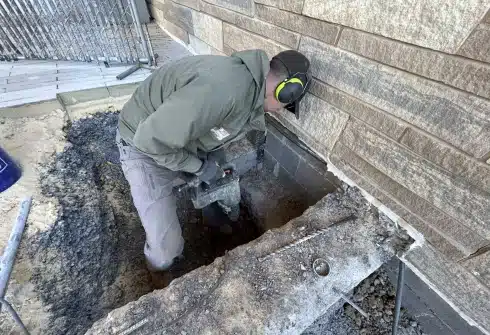 LUX team installing push piers for expert foundation repair services in Northern Virginia, restoring stability and safety to homes.