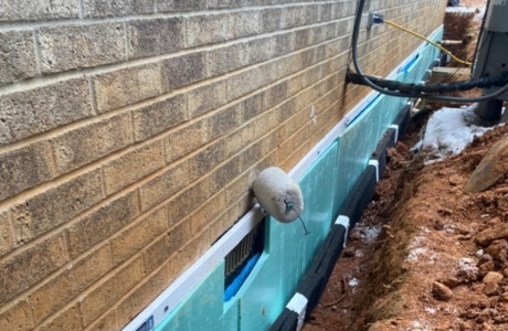 Installed waterproofing membrane for exterior basement waterproofing in Front Royal, VA, to protect the foundation.