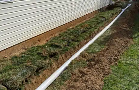 Landscape French drains installation in Berryville, VA, to redirect water away and prevent basement flooding.