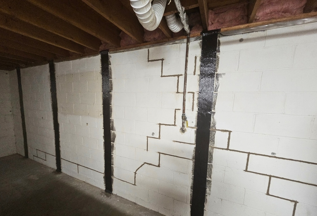 Reinforced basement wall after crack repair in Front Royal, VA, stabilized using carbon fiber straps for long-term protection.