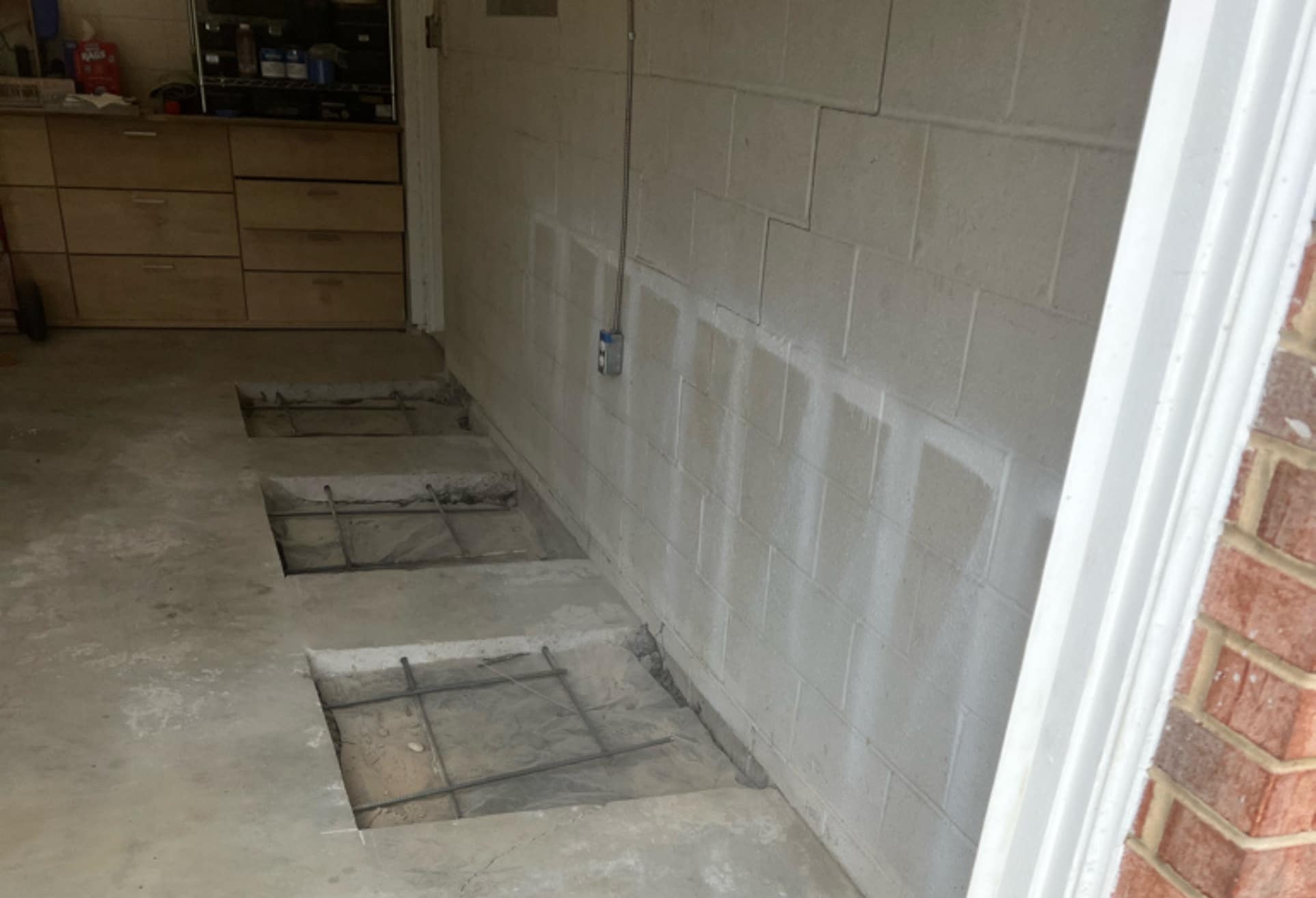 Stabilized garage foundation after push pier installation in Winchester, VA, with level floor and repaired wall cracks.