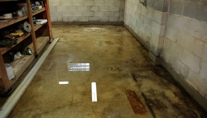 Basement flooding in a Charles Town, WV home after heavy rainfall, highlighting the need for expert basement waterproofing services.