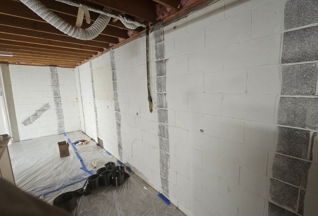 Cracked basement wall before repair in White Post, VA, showing signs of shifting and water damage.