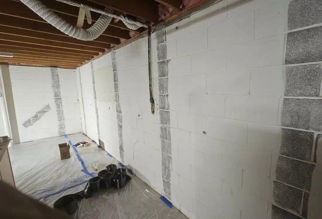 Cracked basement wall before repair in White Post, VA, showing signs of shifting and water damage.