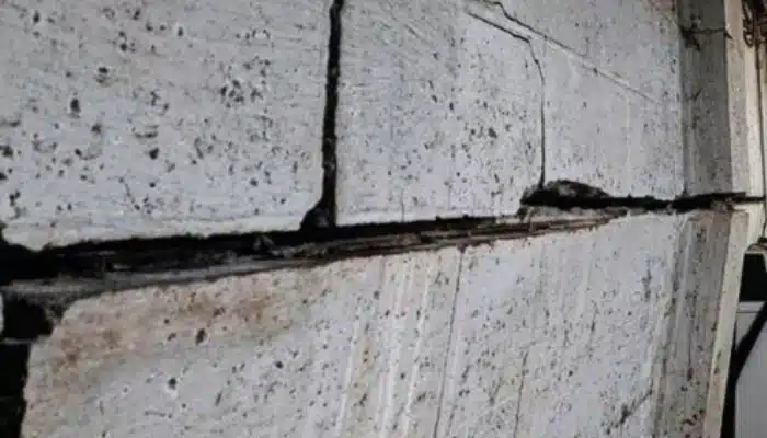 Bowing basement wall in Harpers Ferry, WV, caused by excessive moisture and hydrostatic pressure, requiring waterproofing services.