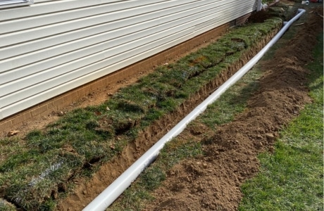 Landscape French drains installation in Charles Town, WV, directing water away from the foundation to prevent moisture problems.
