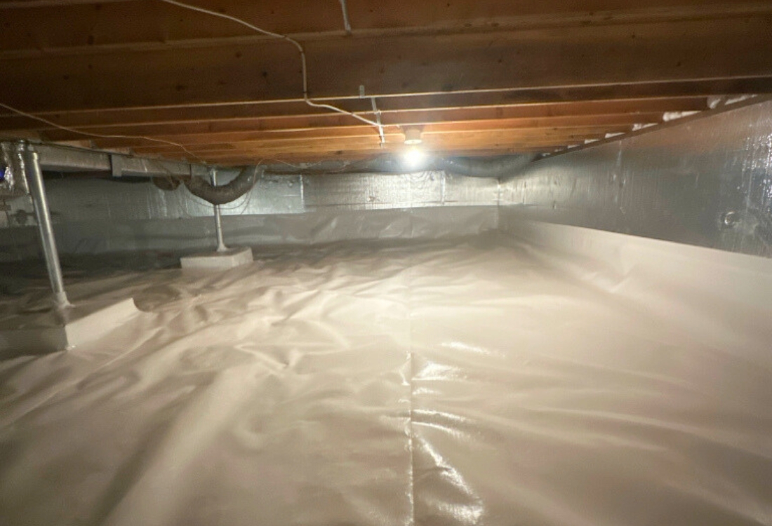 Encapsulated crawl space, with drainage system and support posts installed after wet crawl space repair in Winchester, VA.
