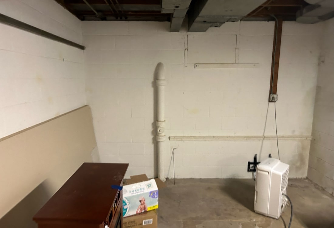 Water stains and damp conditions before wet basement repair in Gainesville, VA.