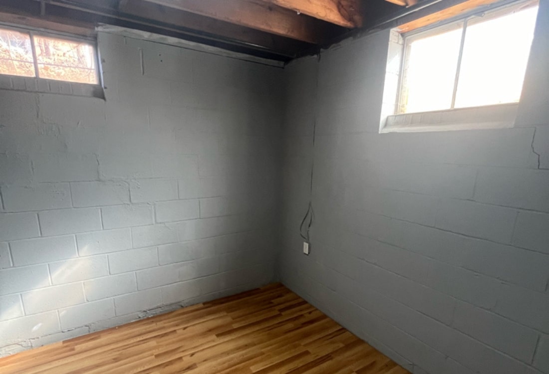Cracked wall and uneven floor in White Post, VA, showing foundation settlement before push pier installation.