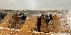Steel push piers and wall pins installed for foundation stabilization at a residential property in Front Royal, VA.