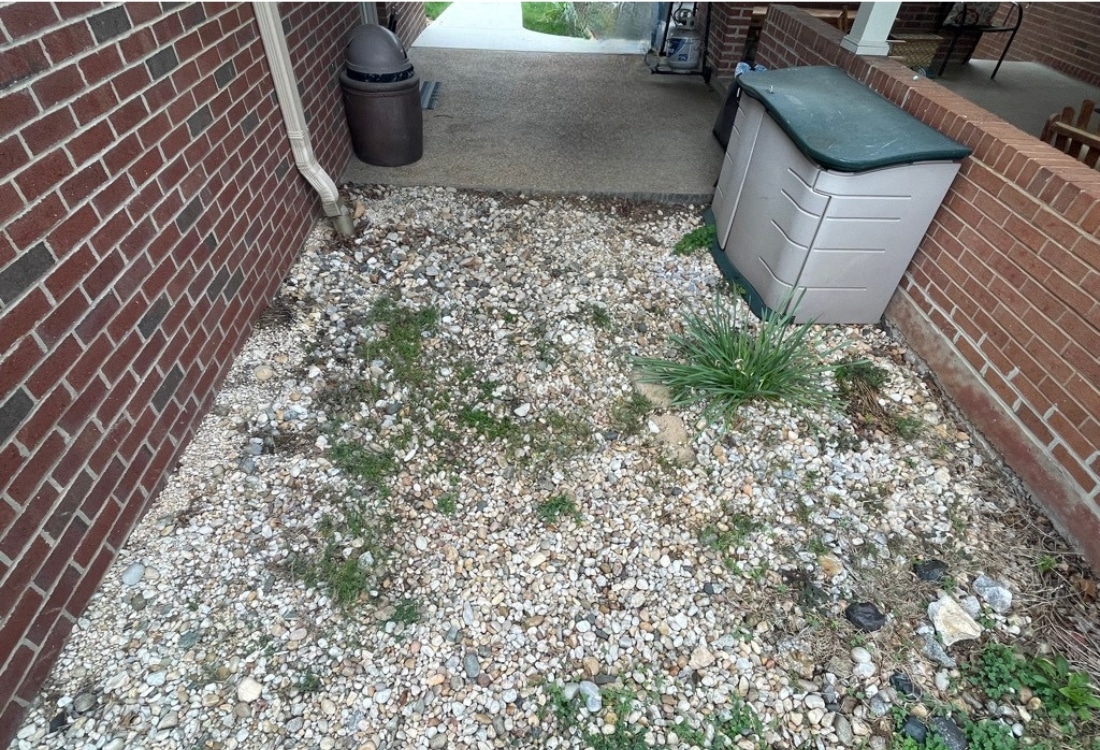 Uneven pea gravel walkway outside home causing safety and drainage issues before concrete installation in Woodstock, VA.