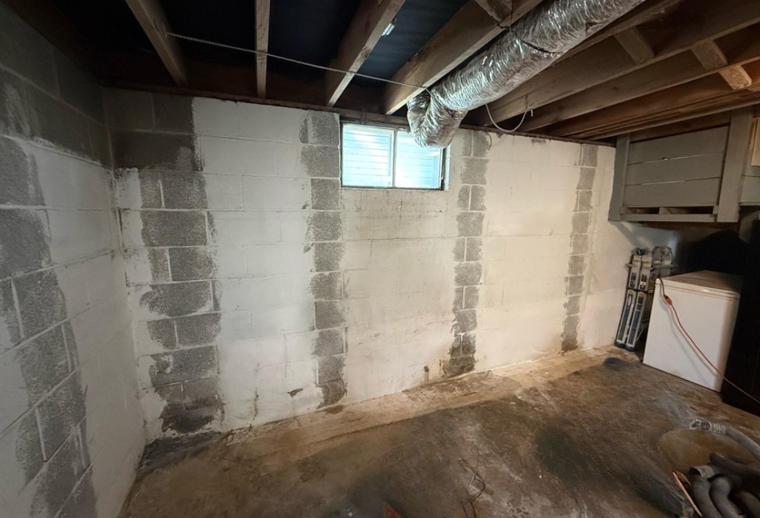 Damaged basement wall with horizontal cracks and bulging before the carbon fiber basement wall repair