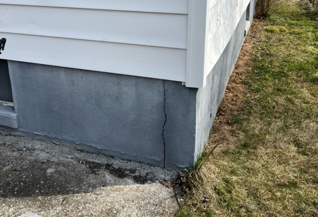 Basement foundation with cracks before the basement wall carbon fiber repair in Stephens City, VA.