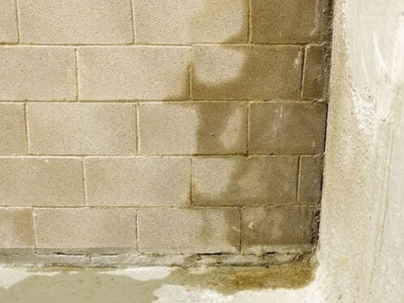 Water seeping through cracks in a foundation wall, creating pathways for water in crawl space in White Post, VA.