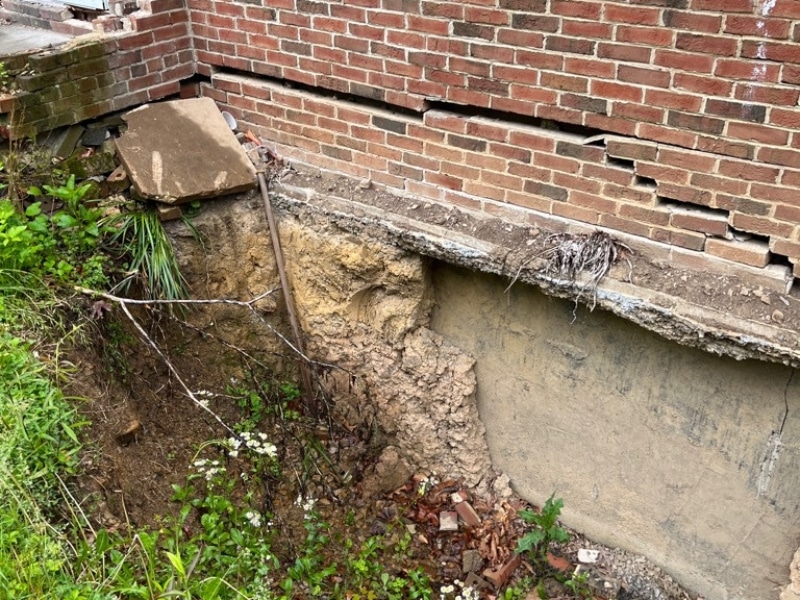 Losing soil around a foundation due to soil settlement, leading to seeping water into crawl space in Flint Hill, VA.