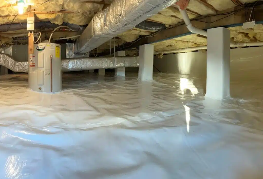 Class 1 vapor barrier installed on crawl space walls and floor during crawl space encapsulation in Fairfax, VA.