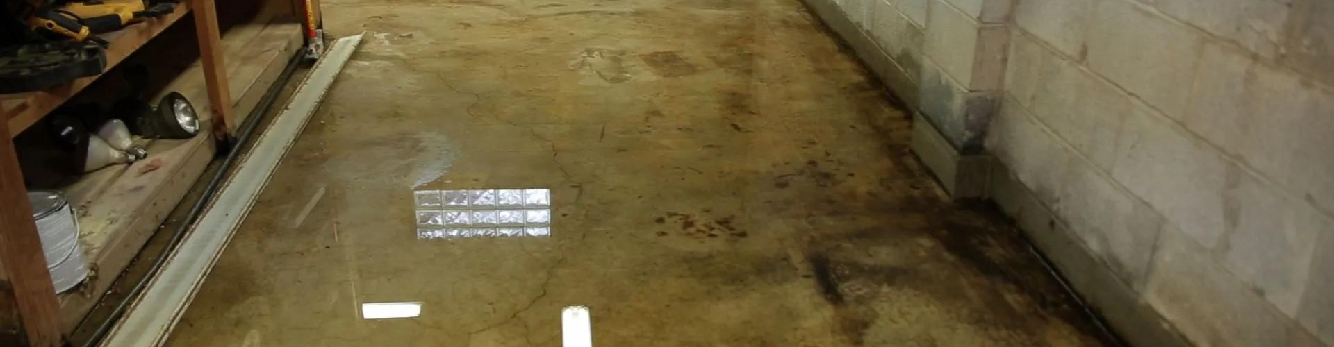 Flooded basement in Northern Virginia home after heavy rain, before waterproofing repair.