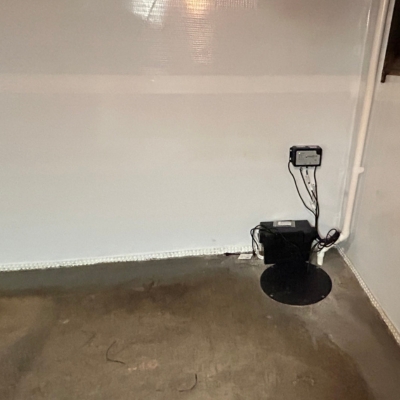 Sump pump system installed in a basement to automatically remove standing water, a basement flooding solution in Martinsburg, WV.