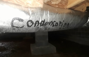 Condensation forming on the window due to high humidity, signs of moisture under the house in Harpers Ferry, WV.