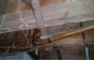 Corroded metal pipes in crawl space, signs of moisture under the house in Bristow, VA.