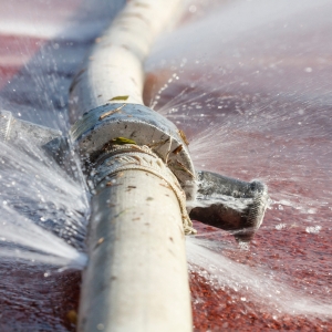 Burst plumbing pipe spraying water and contributing to basement flooding in Brambleton, VA.