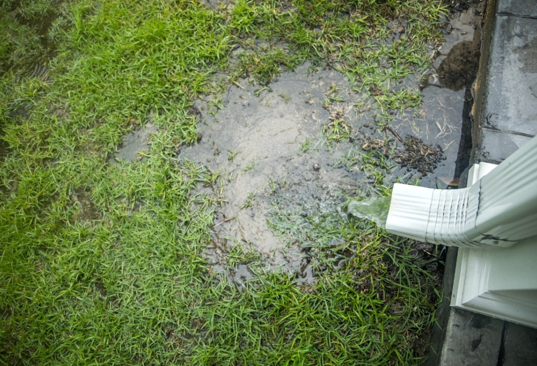 Short downspout draining too close to the home's foundation, a common cause of structural damage in Reston, VA, houses.