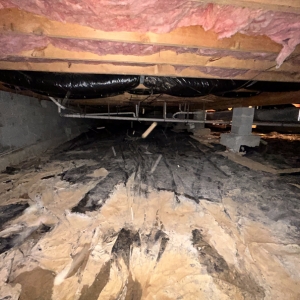 A poorly installed or damaged vapor barrier, allowing ground moisture to rise, causes of damp crawl space in Reston, VA.