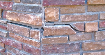 Cracked brick foundation wall showing early signs to prevent further damage, an advantage of foundation repair in Southbridge, VA.