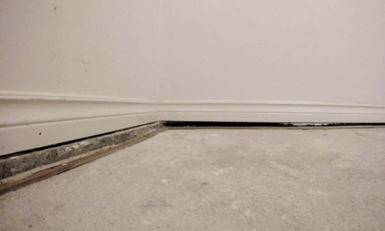 An unlevel basement slab floor, a sign of foundation problems needing house foundation repair services in Charles Town, WV.