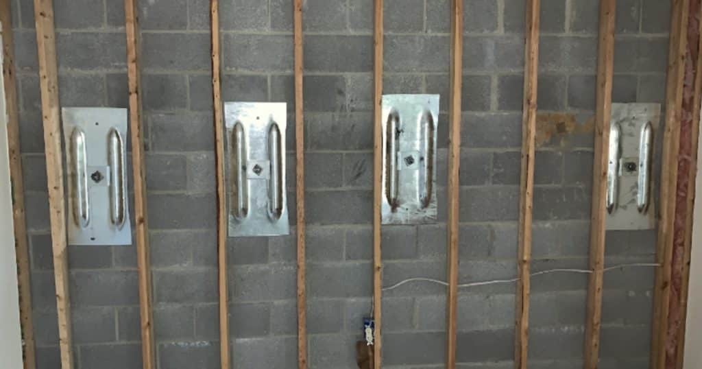 Wall anchors reinforcing cracked basement wall in White Post, VA, strengthening foundation and preventing further bowing.