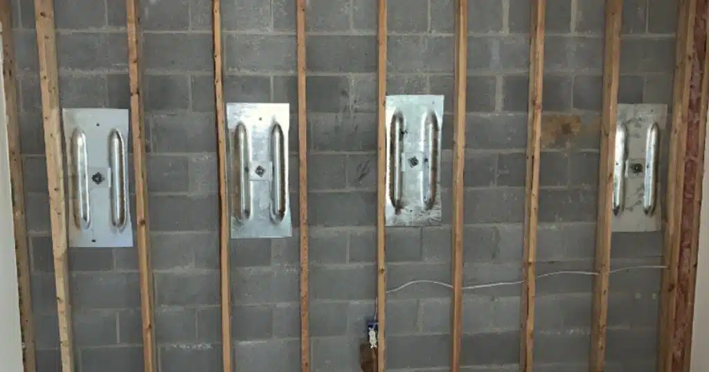 Wall anchors reinforcing cracked basement wall in White Post, VA, strengthening foundation and preventing further bowing.