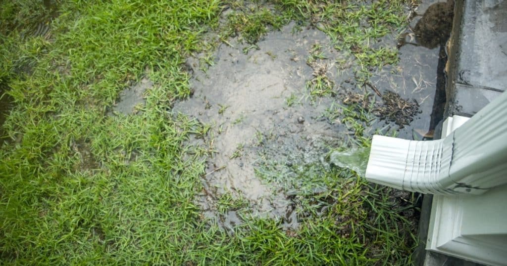 Short downspout draining rainwater too close to the home’s foundation, downspout drainage issues in Fairfax, VA.