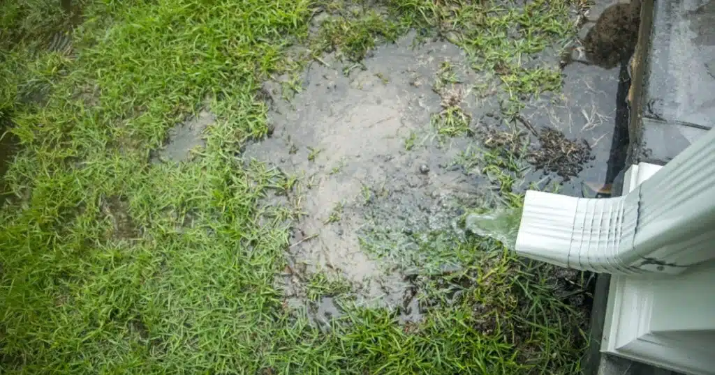 Short downspout draining rainwater too close to the home’s foundation, downspout drainage issues in Fairfax, VA.
