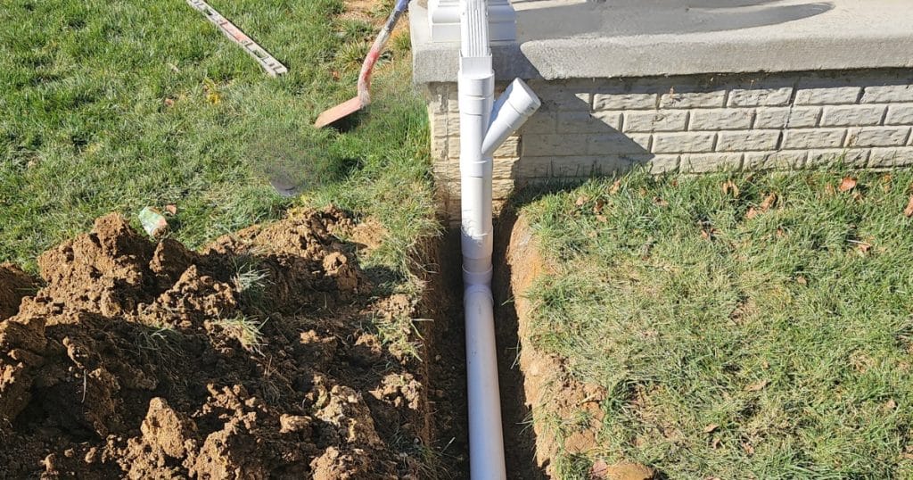 An installed extended downspout drainage in an Alexandria, VA home, directing water farther from the home.