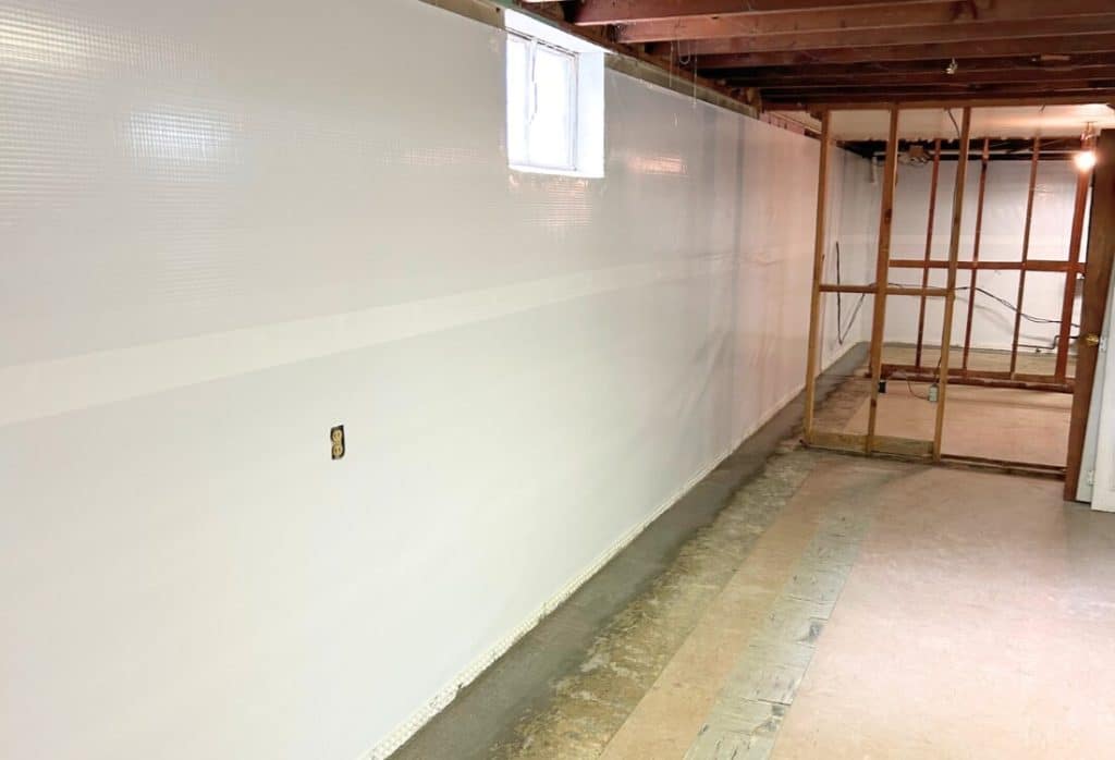 A vapor barrier installed on a basement wall to block moisture and reduce humidity, a basement waterproofing in White Post, VA.