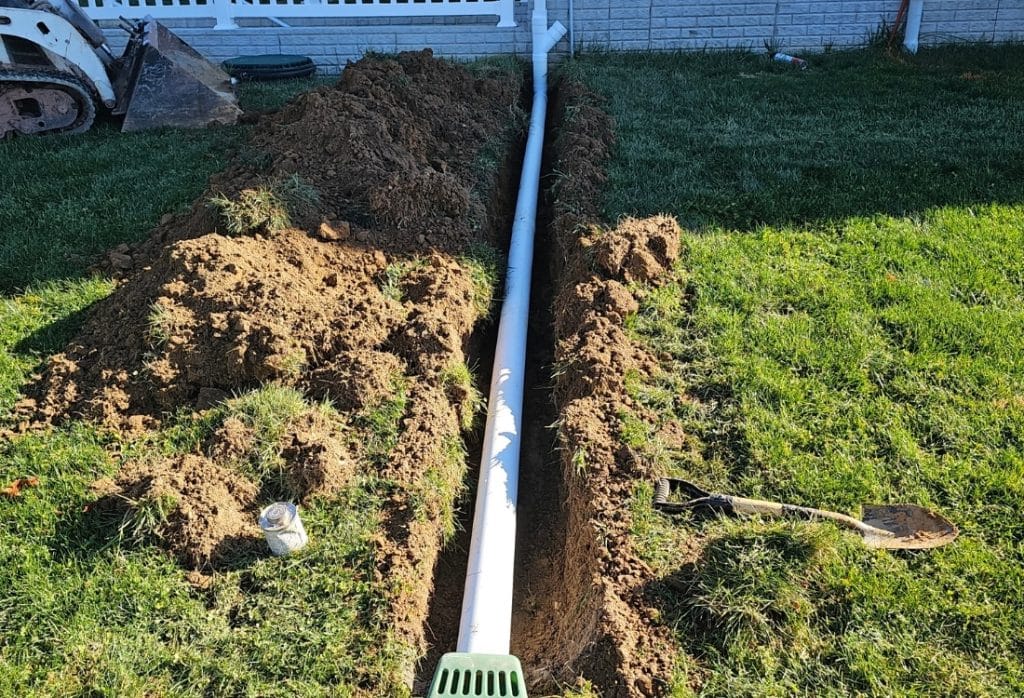 Downspout extension installed as a basement waterproofing method in Flint Hill, VA, to carry rainwater away from the foundation.