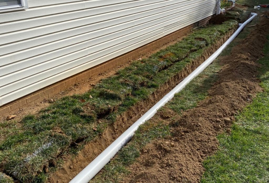 French drain installed in a trench as a basement waterproofing method in Berkeley, WV, to move groundwater away from the foundation.