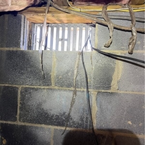 Open crawl space vent allowing outdoor humidity to enter, causes of crawl space wood rotting in Berryville, VA.