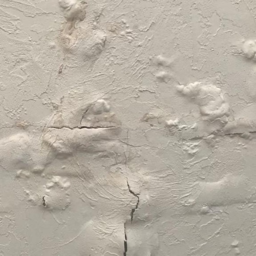 Peeling paint and bubbling drywall that requires professional interior basement waterproofing in Northern VA.