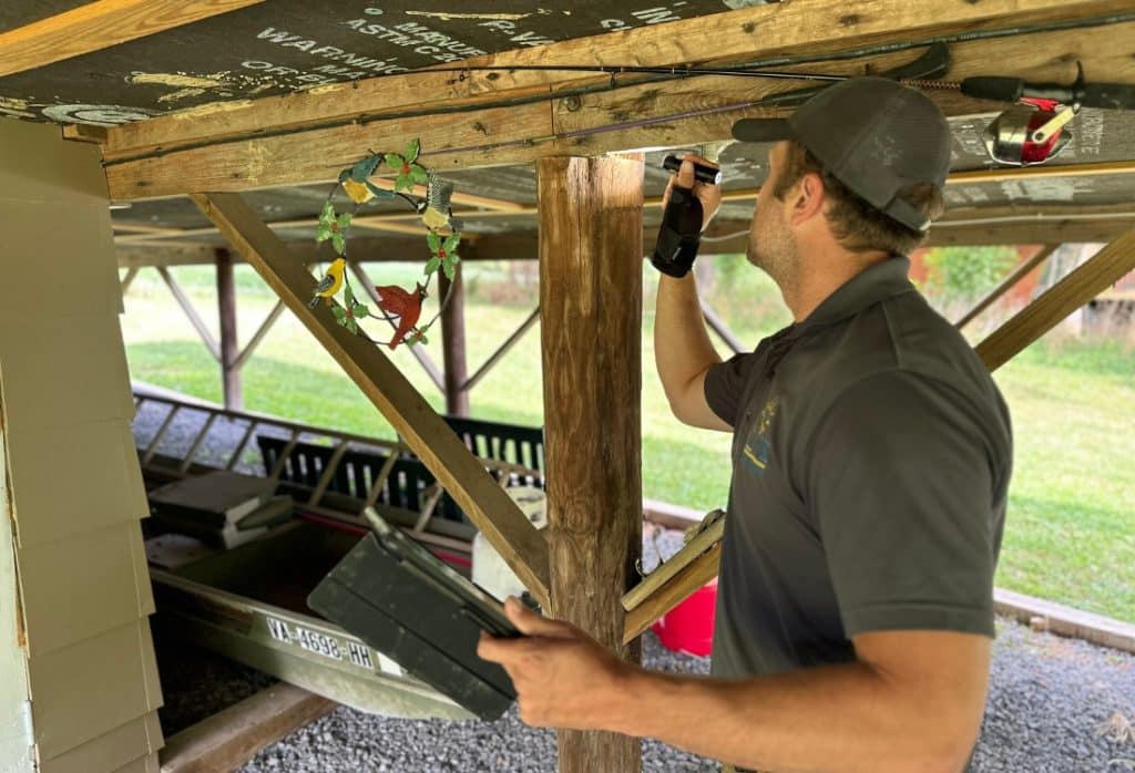 Foundation specialist inspecting floor support and structure in a home with sagging or uneven floors in Fairfax, VA.