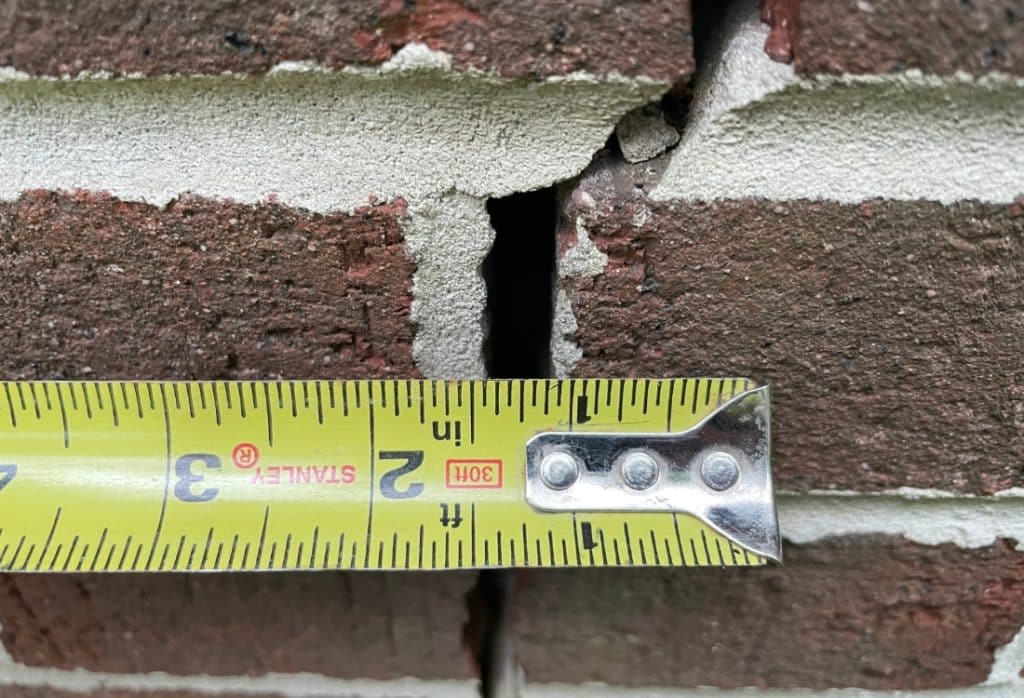 Measuring the wide gap in brick mortar, to track changes when suspecting foundation sinking in Charles Town, WV