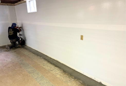LUX team installing a wall vapor barrier to protect the home from water intrusion and moisture damage.