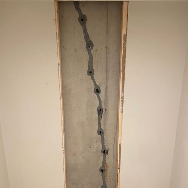 Epoxy-injected foundation crack sealed behind wall, restoring strength as a foundation repair solution in Stephens City, VA.